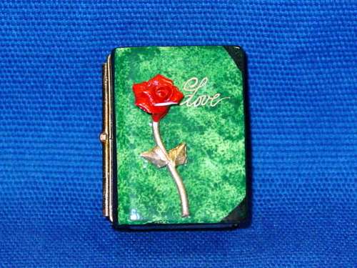 RED ROSE ON GREEN BOOK
